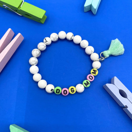<p>Our Howlite 8mm beaded bracelet says "Dog Mom” with detachable tassel (silver tone lobster claw), please let me know if you would like to change any of the wording. Each piece is made to order by me (Jessica) with love and the purest intentions.</p> <p class="p1"> </p>